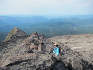 Pam taking a break at ~6600’ elevation – still climbing the boulder fields 