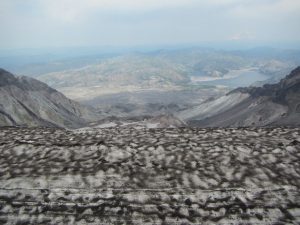The view to the north from Mt. St. Helens crater summit looking at the current lava dome in the crater and viewing the still devastated area from the 1980 blast.